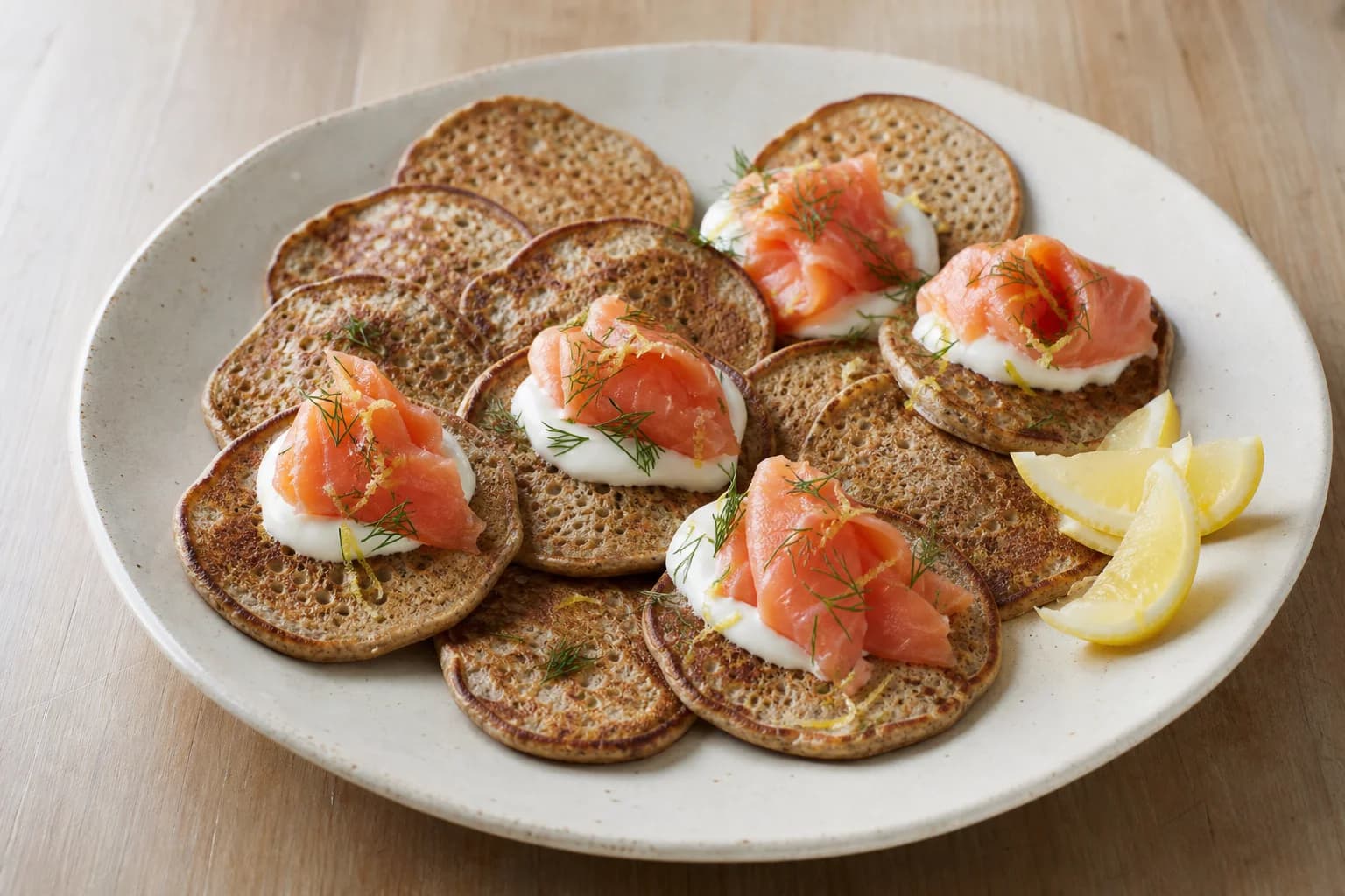 Small yeast-raised buckwheat blini with sour cream, smoked salmon, dill, and lemon.