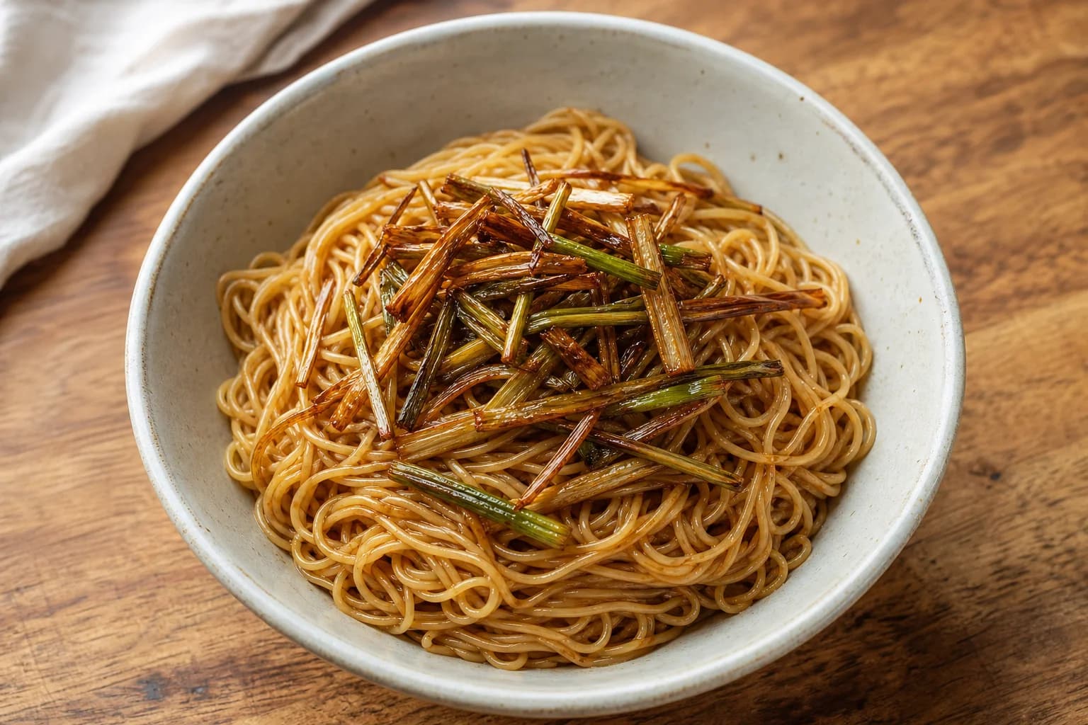 Shanghai scallion oil noodles with springy strands, crisp deep-golden scallions, and a light glossy soy coating.